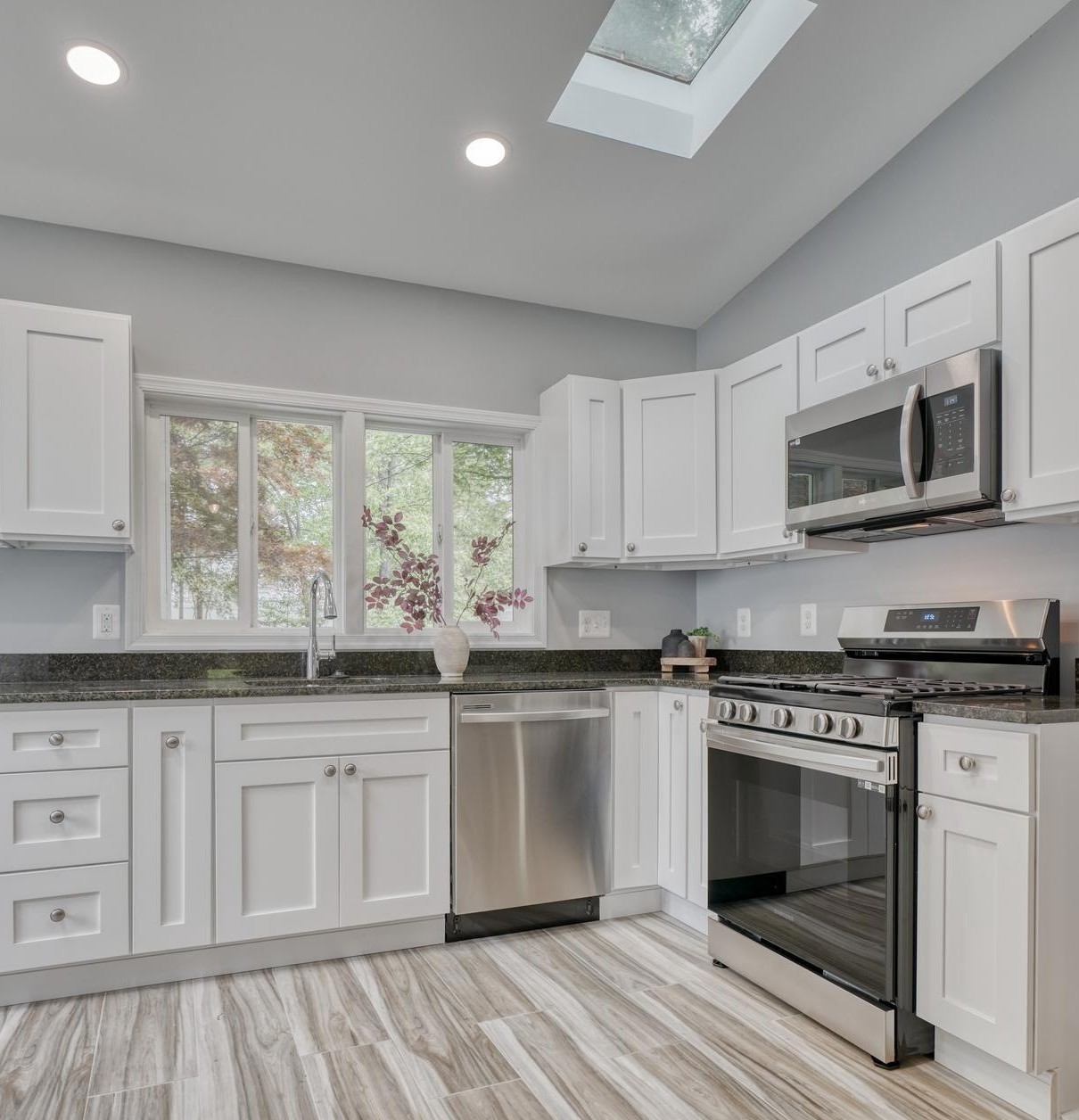 Modern open kitchen with granite countertops and stainless steel appliances